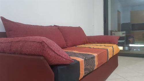 a couch with a blanket on top of it at Home Sweet Home 3 - Guest House in Tirana