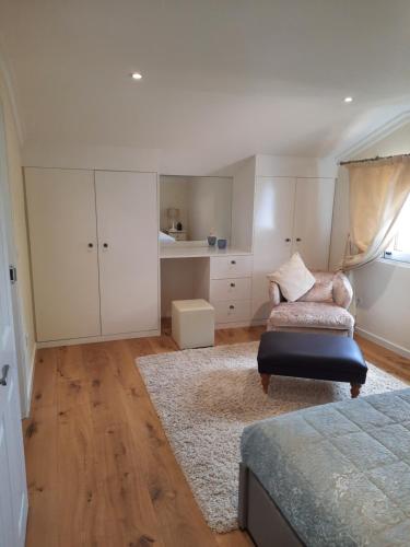 a bedroom with white cabinets and a bed and a rug at Casa Del Mar in Ponta do Sol