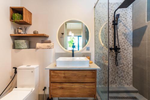 a bathroom with a sink and a shower at ONE BAY Residence Apartment 3 Luxury Unit Grand Baie in Pereybere