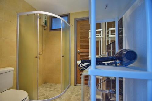 a bathroom with a shower and a sink and a toilet at Blu Beach Haven in Hua Hin