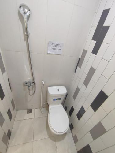 a small bathroom with a toilet in a stall at La Tana Hotel in Bagongsabrangan