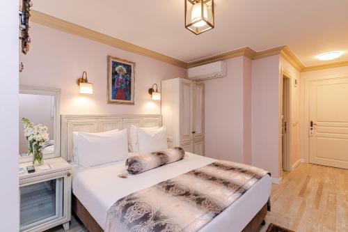a bedroom with a large white bed in a room at Agora Guesthouse in Istanbul