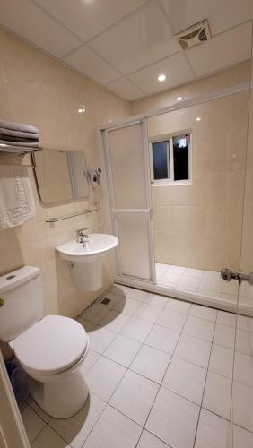 a bathroom with a toilet and a shower and a sink at Xi Yin Zhi Su in Pingxi