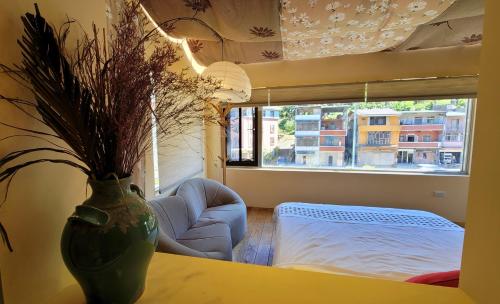 a living room with a vase on a table at Xi Yin Zhi Su in Pingxi