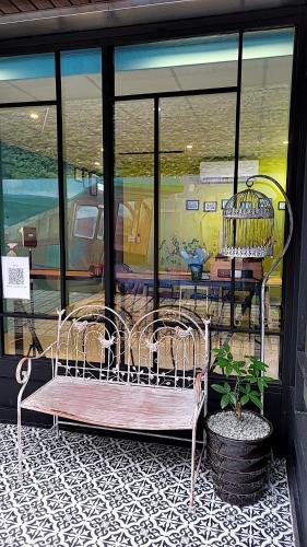 a couple of chairs sitting in front of a window at Xi Yin Zhi Su in Pingxi