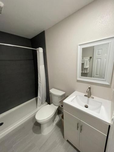 a bathroom with a white toilet and a sink at Fontana Inn in Fontana