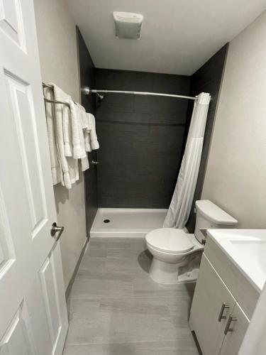 a bathroom with a white toilet and a shower at Fontana Inn in Fontana