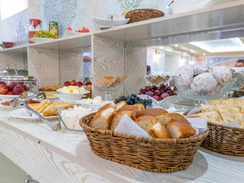 a buffet with baskets of bread and other food at Grand Vizir Hotel in Khiva