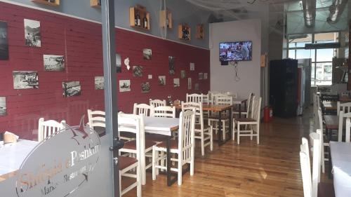 a dining room with white tables and white chairs at Home Sweet Home 3 - Guest House in Tirana