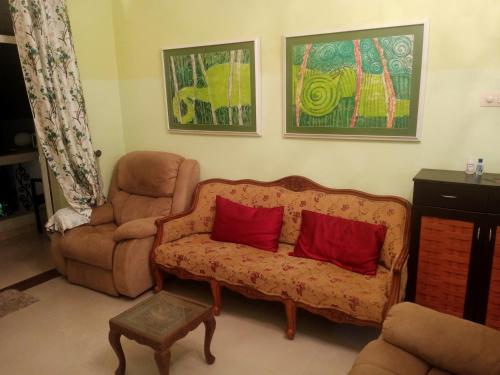 a living room with a couch and a chair at River side apartment in Cavelossim