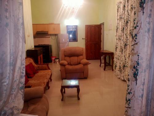 a living room with a couch and a chair at River side apartment in Cavelossim