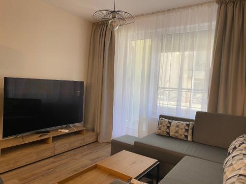 a living room with a large flat screen tv at Arletti Luxury Apartment in Ruse