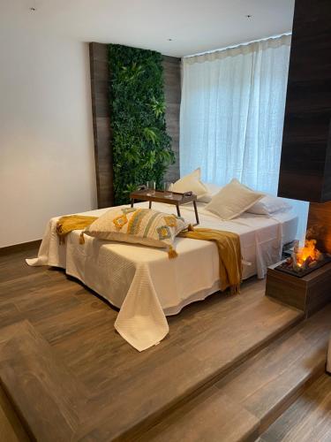 a bedroom with a large bed with a fireplace at Botavara Madrid con Parking incluido in Madrid