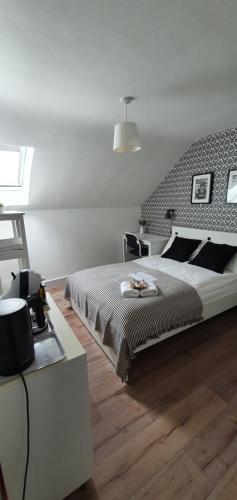 a bedroom with a large bed and a wooden floor at Pasta Factory Guest Rooms in Galway