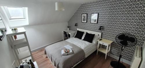 a small bedroom with a bed and a wall at Pasta Factory Guest Rooms in Galway