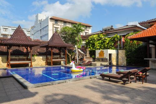 a swimming pool with a pool toy and a raft at Suriwathi Hotel Legian in Legian