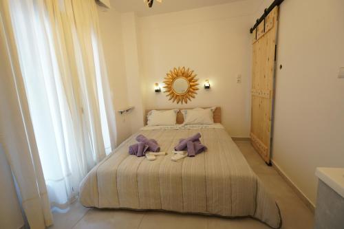 a bedroom with a bed with a mirror and two shoes at "Del Sole" Spa Apartment in Serres