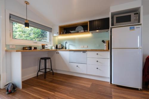 a kitchen with a white refrigerator and a window at Soul Vie Stay in Launceston