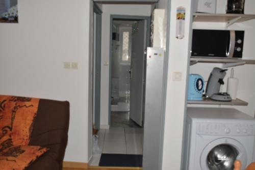 a living room with a refrigerator and a washer at VILLA DUCHATEL in Le Mont-Dore