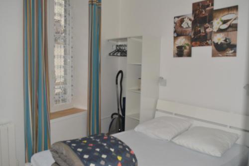 a small bedroom with a bed and a window at VILLA DUCHATEL in Le Mont-Dore