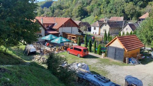 a small village with a red van parked in a yard at Penzión pri studničke Omastiná in Omastiná
