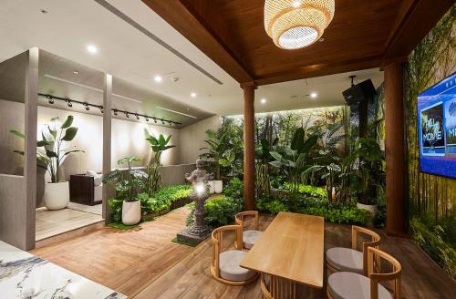 a room with a table and chairs and plants at Motel Lin in Taichung