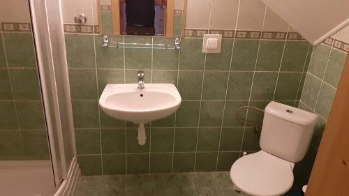 a bathroom with a toilet and a sink at Penzión pri studničke Omastiná in Omastiná