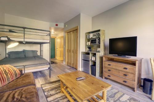 a living room with a bunk bed and a television at TM225A Tucker Mtn Lodge Hotel Room in Copper Mountain