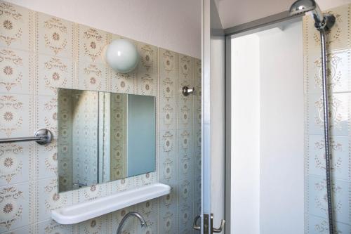a bathroom with a mirror and a shower at Argonaftis Spetses in Spetses
