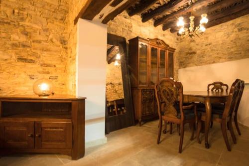 a dining room with a wooden table and chairs at Whitestone Mill in Pano Lefkara
