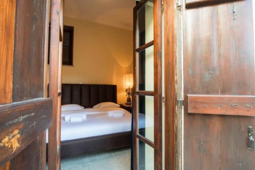 a room with a bed and a door leading to a bedroom at Whitestone Mill in Pano Lefkara