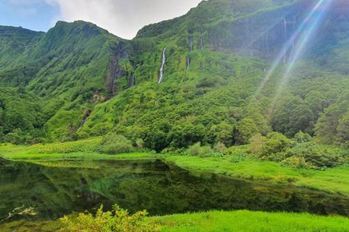 a mountain with a waterfall and a body of water at Monchique Islet View House T2 in Faja Grande