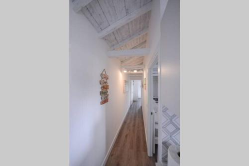a hallway with white walls and a wooden ceiling at Monchique Islet View House T2 in Faja Grande