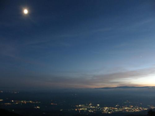 a view of the moon over a city at night at Hotel Garni Gästehaus Karin in Sankt Stefan im Lavanttal