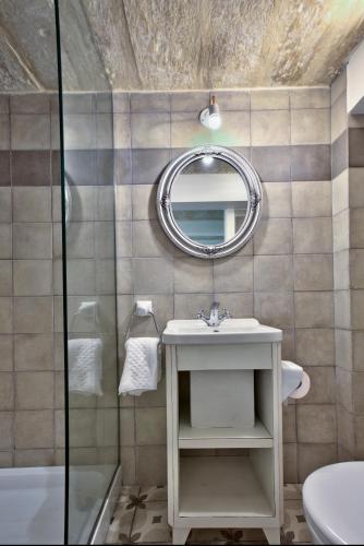a bathroom with a sink and a mirror at Chateau La Vallette - L-Ghorfa Suite in Valletta