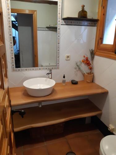 a bathroom with a sink and a mirror at Casa CARMA in Campillo de Ranas