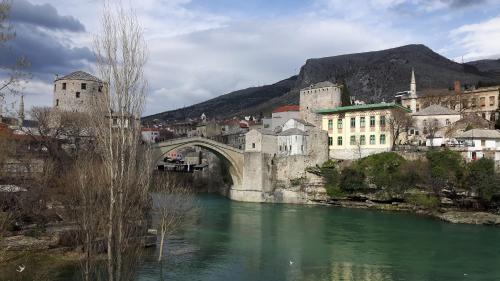 a bridge over a river next to a city at Apartment Neretva in Čapljina