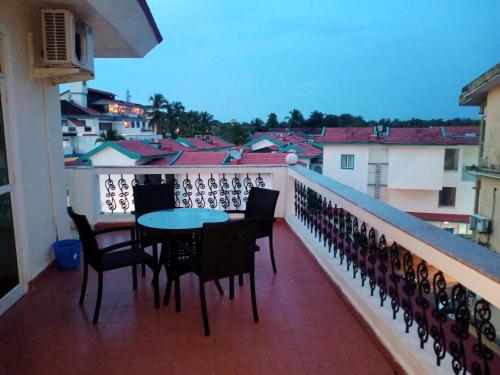 a balcony with chairs and a table on a balcony at River side apartment in Cavelossim