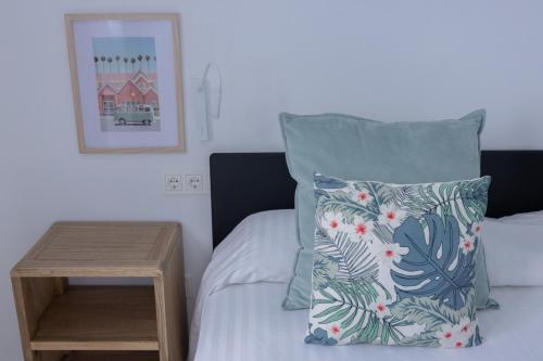 a bedroom with a bed with a pillow and a table at Island Home Fuerteventura in Corralejo