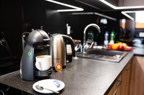 a coffee maker on a counter in a kitchen at Aparthotel New Lux in Wrocław