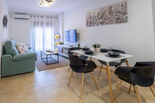 a living room with a dining room table and chairs at Apartamento Boutique Plasencia Centro in Plasencia