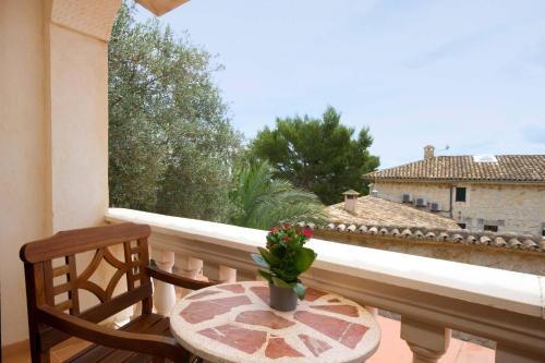 a table and two chairs on a balcony with a window at Monnaber Nou Finca Hotel & Spa in Campanet