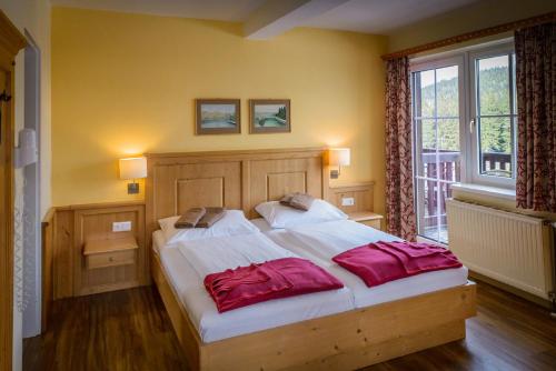 Un pat sau paturi într-o cameră la Alpengasthof Enzian GmbH