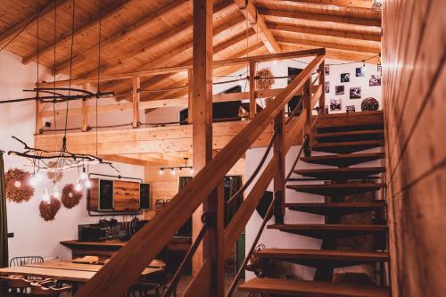 a wooden staircase in a room with a table at Dakota forest retreat in Tsigov Chark