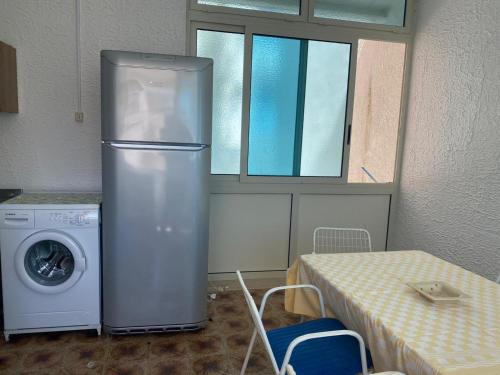 a kitchen with a refrigerator and a washing machine at Villa conchilglia - 30 metri dal mare in Lido Conchiglie