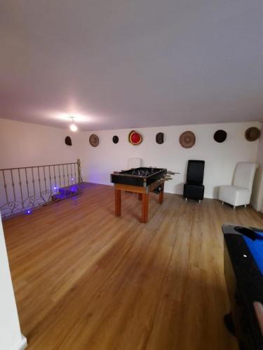 a room with a ping pong table in the middle at Casa Del Mar in Ponta do Sol