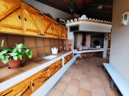 a kitchen with wooden cabinets and a sink at Casa Del Mar in Ponta do Sol