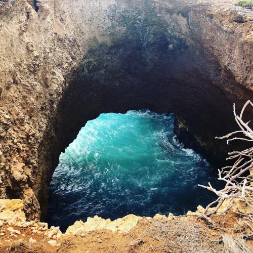 a cave with a blue pool of water at Gites Kaladja in Port-Louis