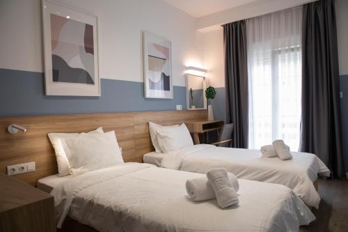 a hotel room with two beds with towels on them at Alexandros in Giannitsa