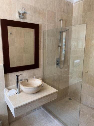 a bathroom with a sink and a glass shower at Spectacular views from this villa in Lapta in Kérynia